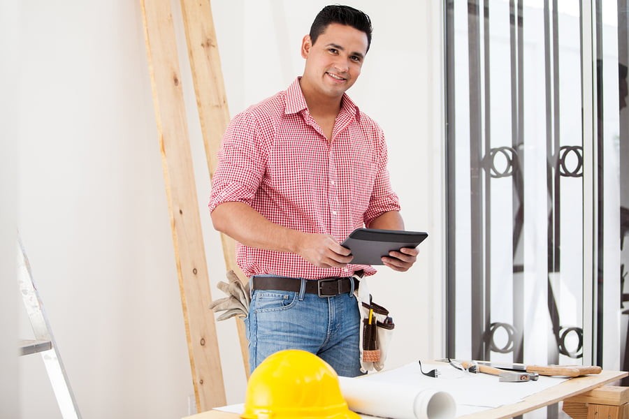 Happy Contractor Using A Tablet with Project Management Workflow Software Happy Contractor Using A Tablet with Project Management Workflow Software