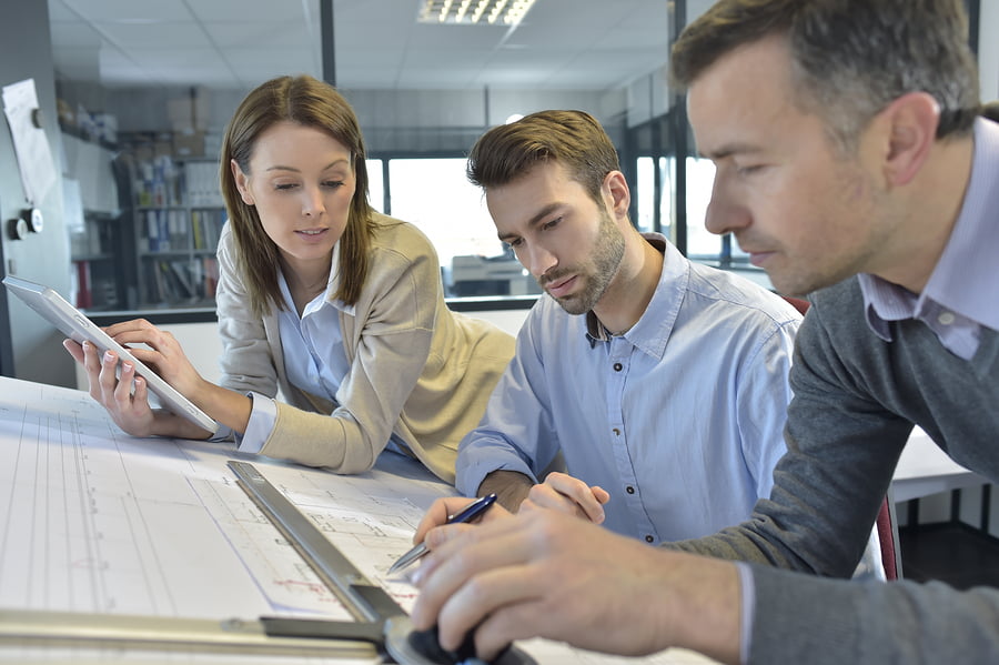 Team of architects working on tasks Team of architects working on tasks